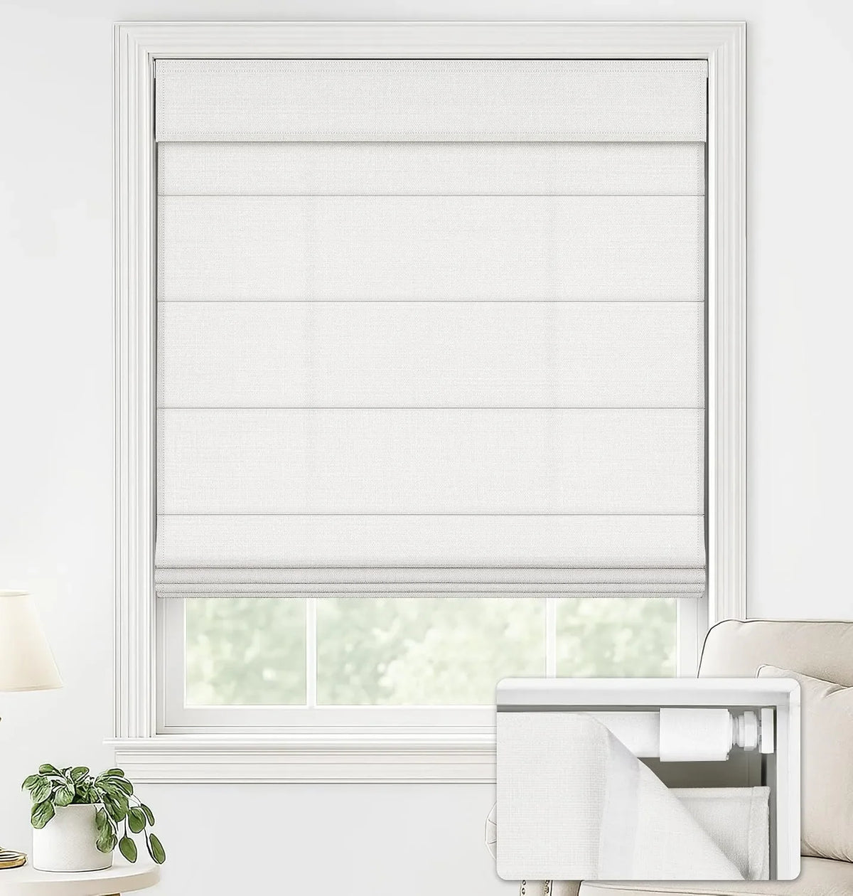 A white Roman shade window blind shown installed on a window in a bright room, with a small inset showing the blind folded and packaged.