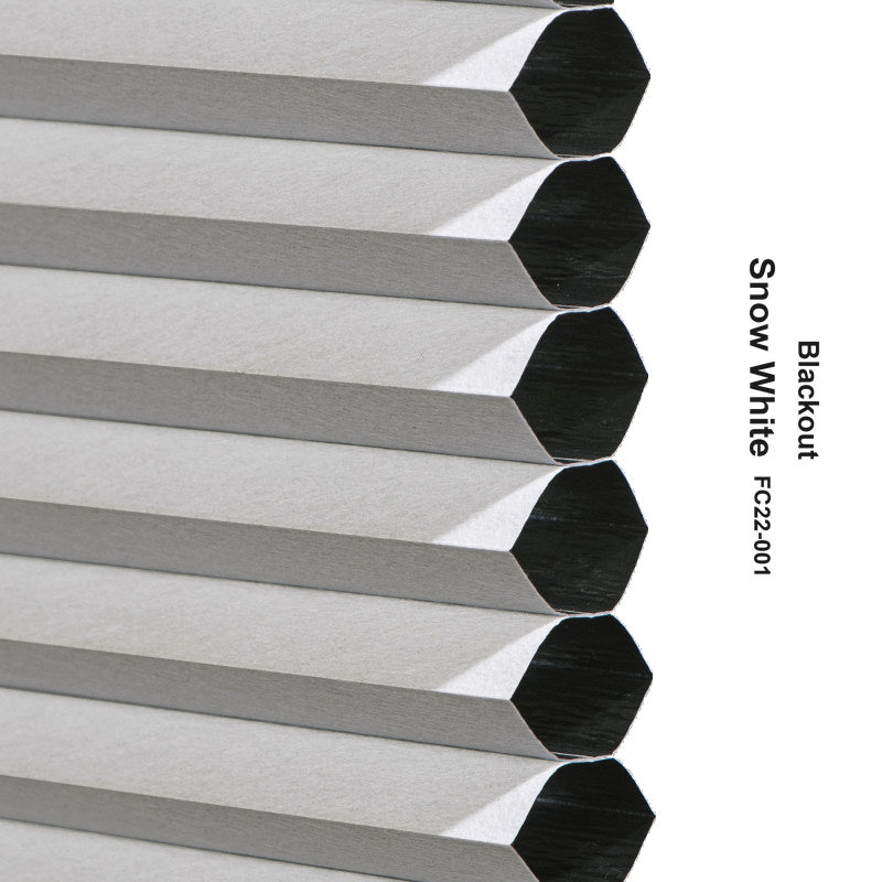 Close-up of a stack of hexagonal aluminum or metal siding panels in a brushed silver finish, with black interior ends visible. Vertical text on the right reads 'Blackout Snow White FC22-001'.