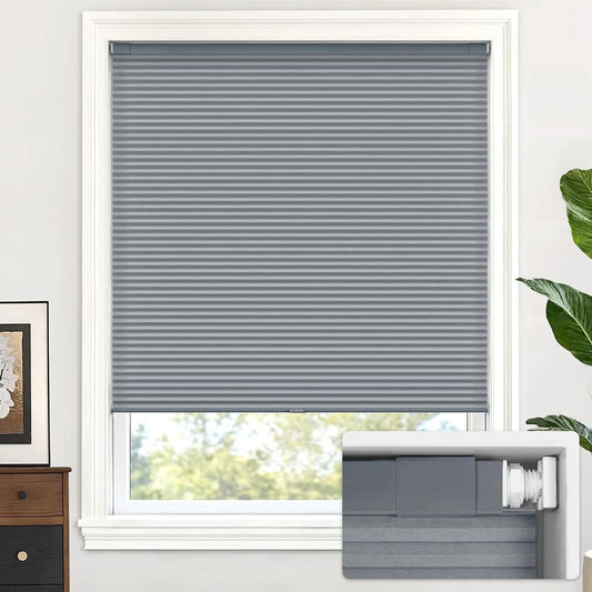 Dark Gray blinds on a window with a white frame, a plant, and a dresser in the background.